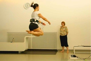 A dancer mid jump wearing monitoring equipment